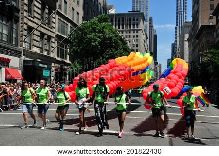 NYC - June 29, 2014:  Event staff members leading the rainbow coloured balloon arches at the start of the 2014 Gay Pride Parade on Fifth Avenue