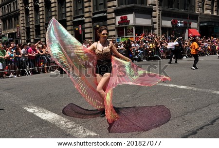 NYC - June 29, 2014:  Marcher with sheer cape-like wings at the 2014 Gay Pride Parade on Fifth Avenue