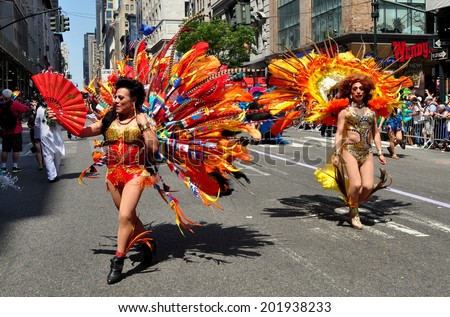NYC - June 29, 2014:  Two members of the Latino Pride group sporting elaborate costumes marching in the 2014 Gay Pride Parade on Fifth Avenue