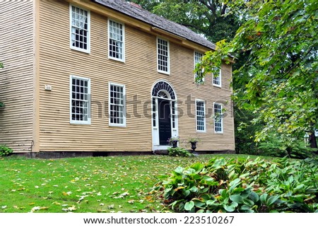 Deerfield, Massachusetts - September 20, 2014:  Plain wooden 18th century home with elaborate fan doorway window