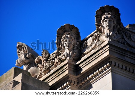 NYC - October 25, 2014:  Ornate beaux arts faces decorate the east front roof line of the Metropolitan Museum of Art on Fifth Avenue