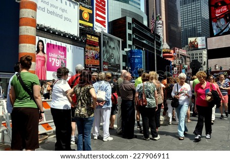 NYC - May 28, 2011:  Crowds queue in line at the TKTS booth in Times Square to buy discounted tickets for Broadway shows
