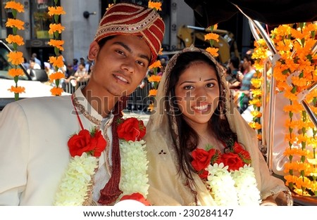 New York City - August 15, 2009:  A handsome young Indian couple in traditional marriage clothing at the India Day Parade on Madison Avenue