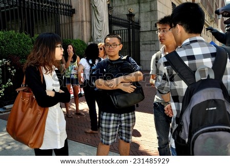 New York City - August 23, 2011:  Group of Asian students chatting in front of the Broadway entrance gates to Columbia University during an matriculation week in late August