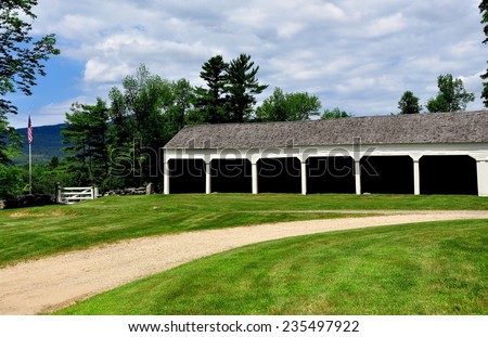 Jaffrey Center, New Hampshire:  A row of wooden stables for parishioner\'s horse carriages next to the 1775 Original Meeting House church
