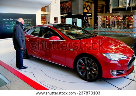 New York City - December15, 2014:  A bright red Tesla battery-powered automobile attracts attention from viewers in the Time-Warner Center atrium at Columbus Circle
