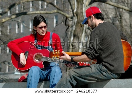 New York City - March 7, 2006:  Two musicians strumming their guitars on the wall in front of Grant\'s Tomb in Riverside Park