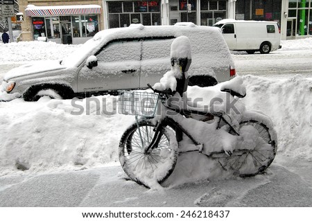 New York City - February 12, 2006:  Delivery bicycles and parked cars on Amsterdam Avenue covered with snow following a winter blizzard