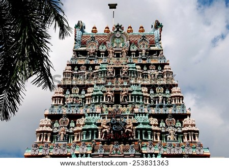 Singapore - December 21, 2007:  The Gopuram Sikhara tower of Sri Thendayuthapani Hindu temple on Tank Road covered with colorful Indian deities