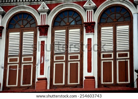 Singapore - December 16, 2007:  Handsome fan windows with louvered shutter windows adorn a 19th century Chinese shop house in Little India  *
