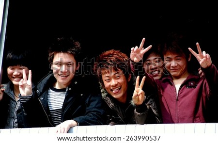 Pengzhou, China - February 12, 2009:  Smiling Chinese teenagers flashing the \