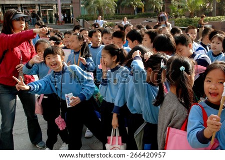 Hong Kong, China - December 11, 2006:  A group of school kids with their teacher on a field trip to the Peak atop Hong Kong Island