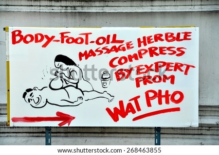 Bangkok, Thailand - December 13, 2010:  Home-made advertising sign for a Thai massage parlor on Sathorn Road