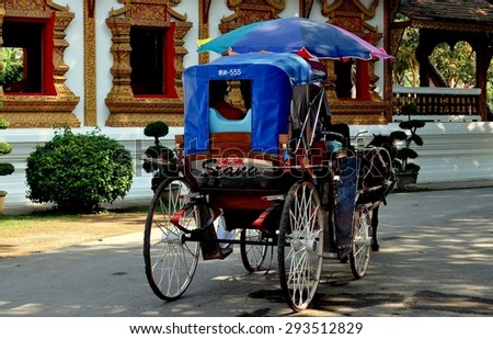 Chiang Mai, Thailand - December 30, 2012:  Horse-drawn carriage offers visitors a guided tour through King Mengrai\'s Wiang Kum Kam Ancient Village