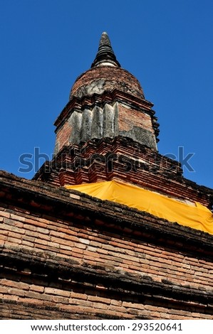 Chiang Mai, Thailand - December 25, 2012:  Medieval brick Wat That Klang Chedi, once a part of the ancient city defense walls