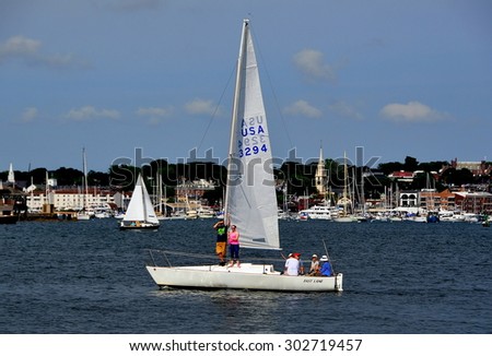 Newport, Rhode Island - July 17, 2015:  The Fast Lane sailing boat cruising the waters of Narragansett Bay with spire of Trinity Church in the background