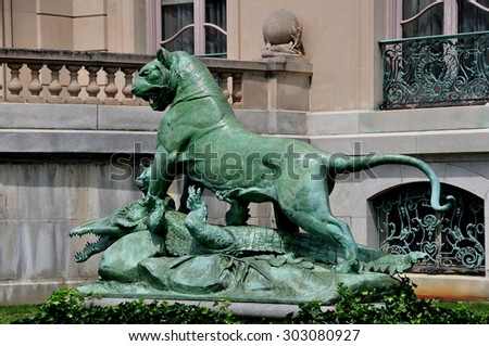 Newport, Rhode Island - July 17, 2015:  Statue of a lion attacking a crocodile in the gardens at 1901 The Elms mansion