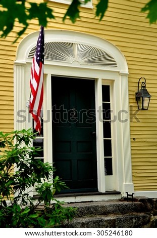Hancock, New Hampshire - July 11, 2013:  Doorway with side windows and finely carved wooden fan adorns an 18th century colonial home