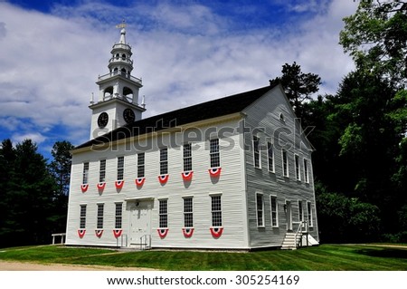 Jaffrey Center, New Hampshire - July 11, 2013:  Red, white, and blue patriotic bunting decorates the windows at the 1775 Original Meeting House church with its elegant steeple and bell tower *