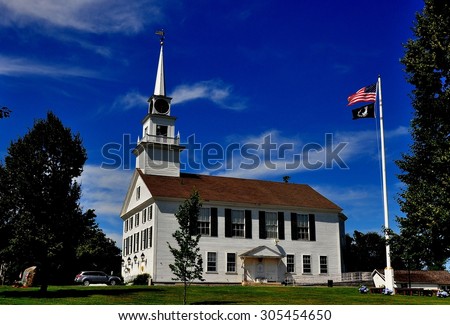 Rindge, New Hampshire - July 11, 2013:  The white wooden colonial 1796 Second Rindge Meeting House church and Town Hall overlooking the Village Green
