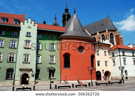 KRAKOW, POLAND - June 8, 2010:  The rounded coral-colour choir of St. Barbara\'s church flanked by 17-18th century mansions in the Maly Rynek *