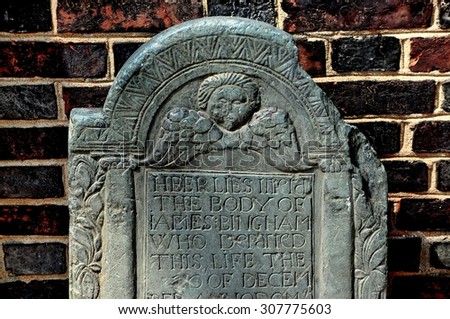 Philadelphia, Pennsylvania - June 25, 2013: 18th century tombstone with winged angel face stands by the entrance door at 1727-1754 Christ Church