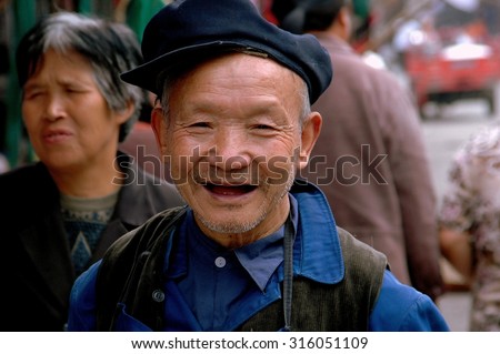 Ao Ping, China - September 14, 2006:  Smiling, elderly, toothless, Chinese man wearing a cap