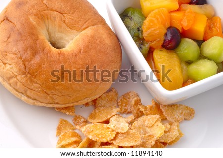 Colorful healthy kids lunch isolated on a white plate with fresh fruits bagel and cereals