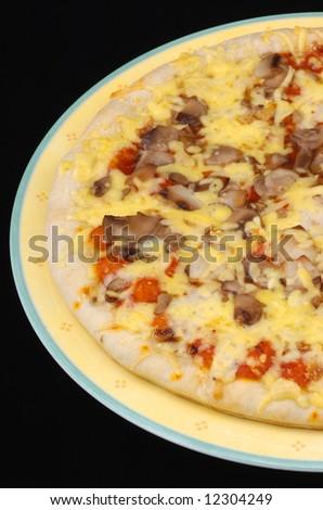Fresh mushroom pizza on a yellow plate