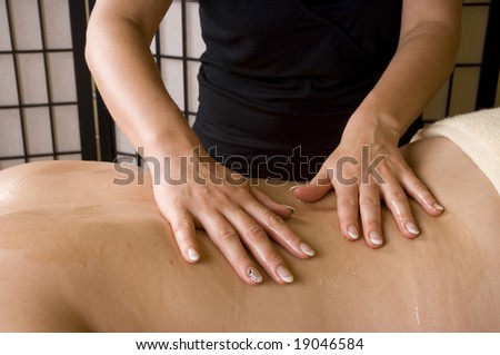 Relax massage therapy inside a spa room, hands the back as a closeup image