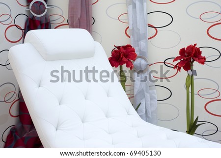 White elegant chair for relaxing time. Detail of a modern designed living room.