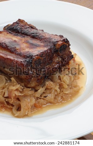 Pork ribs glazed and roasted, served on sauerkraut.