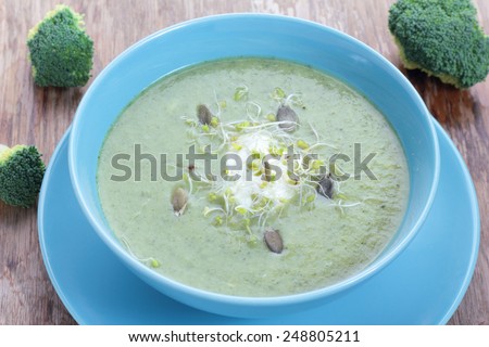 Broccoli puree soup with pumpkin seeds and sprouts.