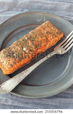 Nice piece of smoked salmon seasoned with salt and chopped dill.