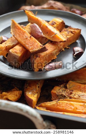 Sweet potato roasted chips on a tin plate.