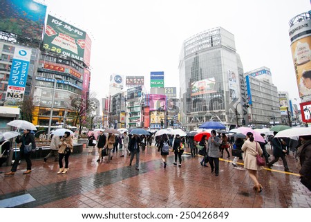 TOKYO, JAPAN - MARCH 20: People acrossing the crosswalk in raining day on March 20, 2014.Shibuya crossing is one of busiest places in Tokyo and is recognized thanks to being featured in multiple films