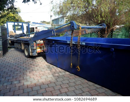Truck delivering a empty waste skip
