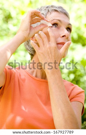 Elderly Person Using Eye Lotion