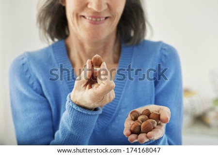 Elderly Person Eating Dried Fruit