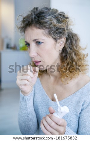 Woman Using Spray In Mouth