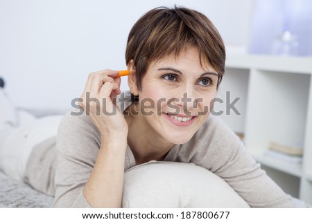 Middle aged woman using noise control