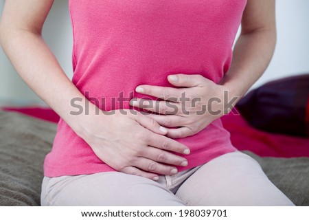 Woman suffering from abdominal pain.