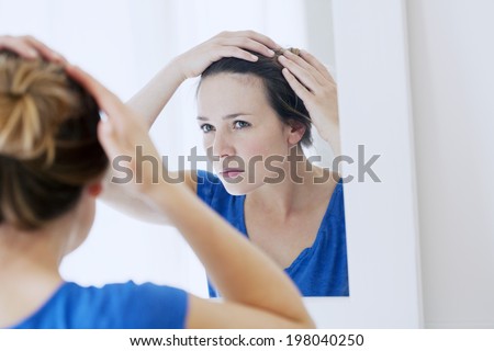Woman looking in a mirror.