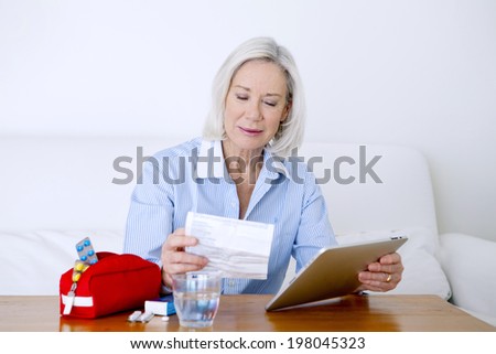 Senior woman reading medical informations on the internet.