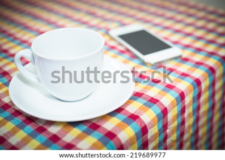 Cup of tea on the table with mobile phone