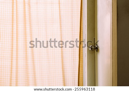 Door near the curtain with vintage style.