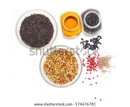 black rice and beans in glass dishes with spices on a white background