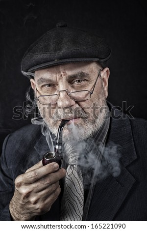 Senior man with smoking pipe