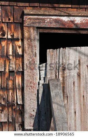 Boarded door of an old abandoned barn with signs of fire