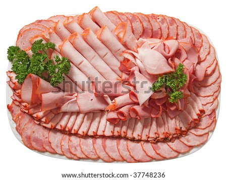 Plate of assorted cold cuts - ham, sausage and turkey breast garnished with parsley leaves